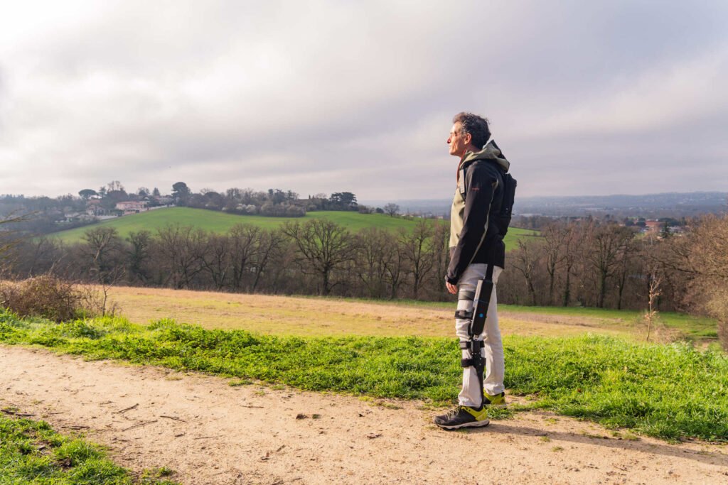 Person wearing the DREEVEN mobility-assistance exoskeleton outdoors