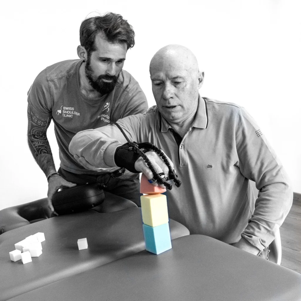 Patient training hand movement with the Emovo Clinic rehabilitation device