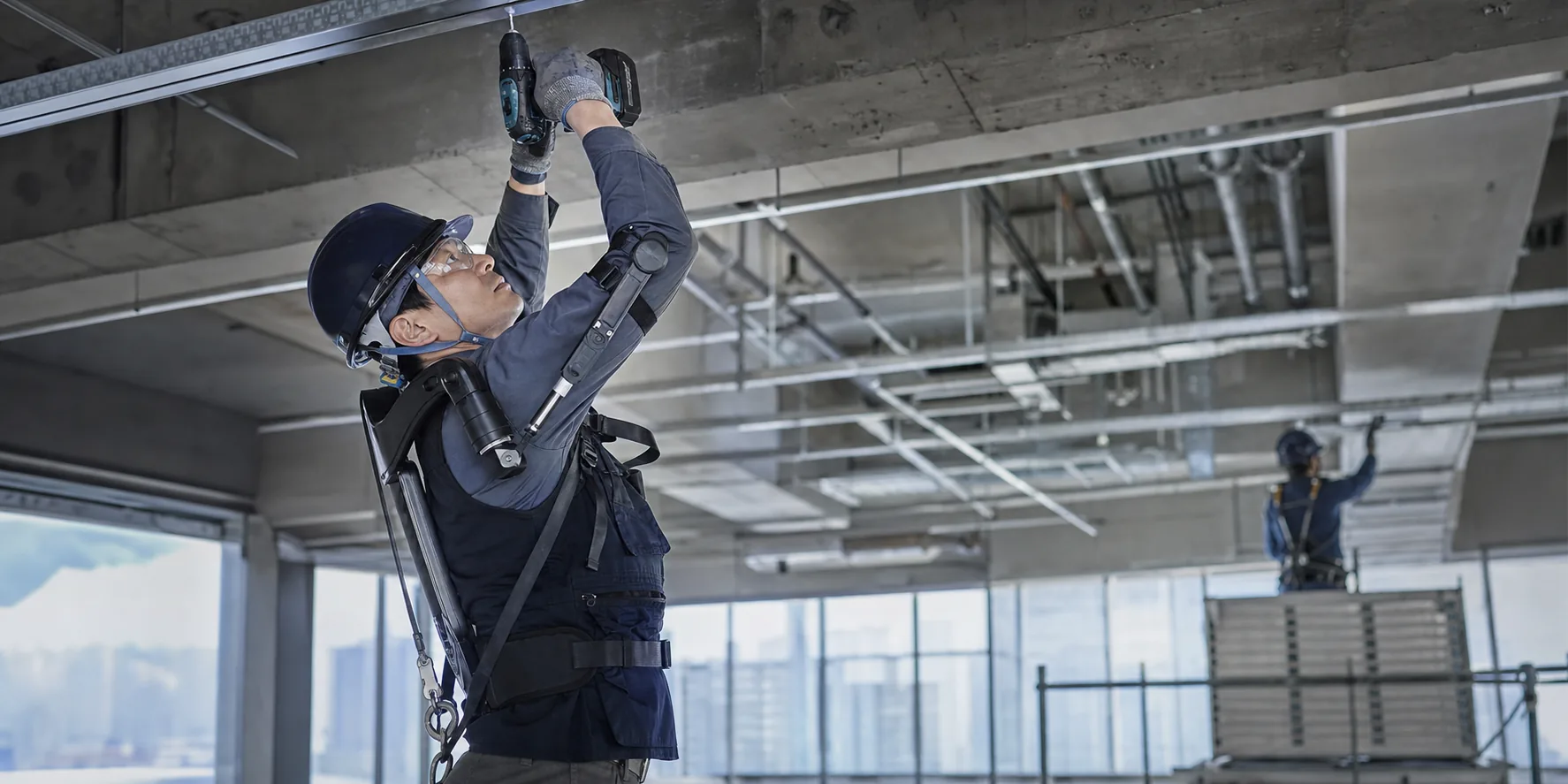 Illustrative construction worker using a shoulder-support exoskeleton for overhead work